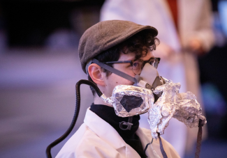 Person depicted in tan cap wearing a breathing mask