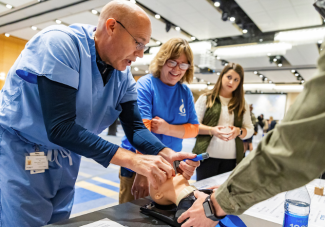 One person showing an intubation diorama to two curious people